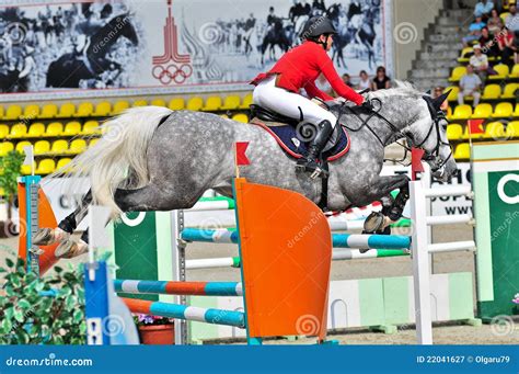 Jockey Jumps Over A Hurdle At The Competition Editorial Photography