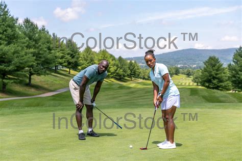 31_Black_male_black_ female_ golfers_ concentrating_ playing (Commercial) — InColorStock