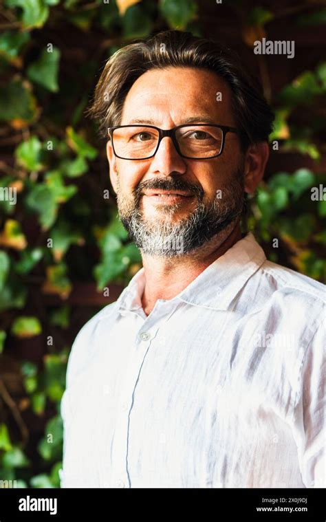 Portrait Of Adult Mature Handsome Bearded Man With White Shirt Smiling