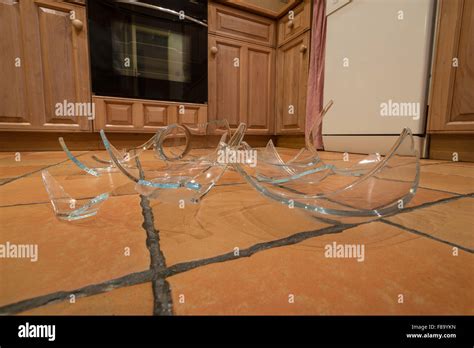 Remnants Pile Of Broken Glass On Floor After Accident And Pyrex Glass Bowl Slipped Out Of Wet