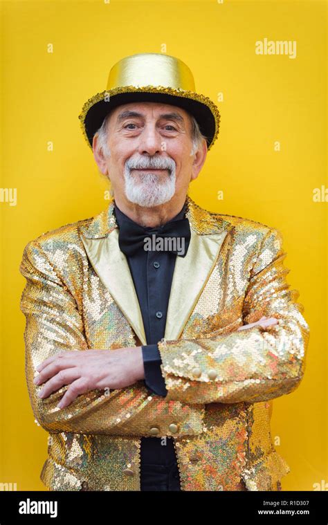 Funny And Extravagant Senior Man Posing On Colored Background