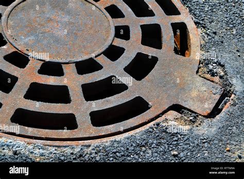 Cast Iron Manhole Cover Storm Sewer In The Park Close Up Stock Photo