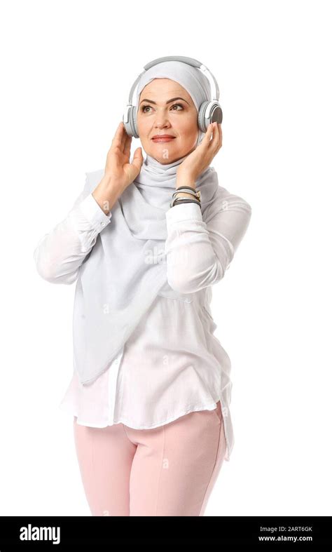 Beautiful Mature Muslim Woman Listening To Music On White Background