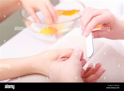 Beautician With File Filing Nails Female Client Woman Spa Beauty Salon