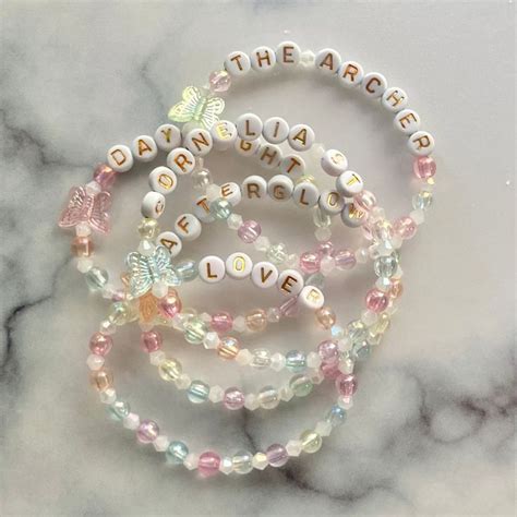 Three Bracelets With Words On Them Sitting On Top Of A Marble