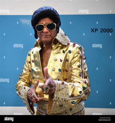 Elvis Impersonator Alfred Vaz Poses For A Portrait Prior To Boarding