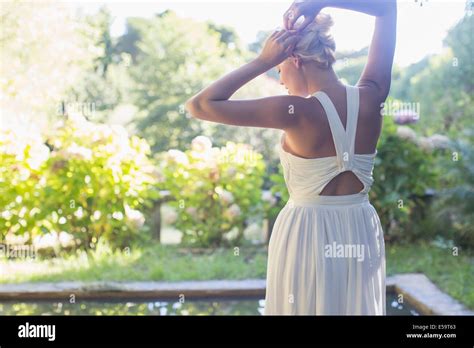 Woman Tying Up Her Hair Outdoors Stock Photo Alamy