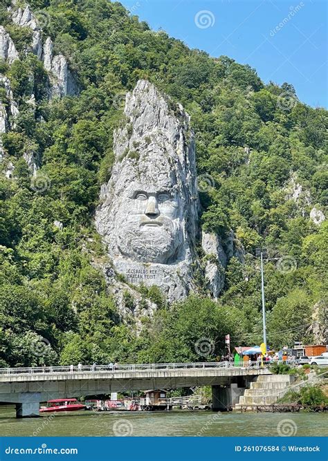 Vertical Shot Of Rock Sculpture Of Decebalus And Lush Green Vegetation