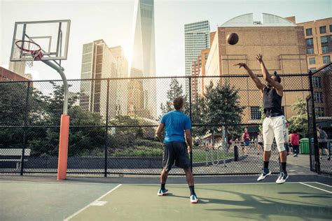 afroamerican athlethes playing basketball outdoors basketball