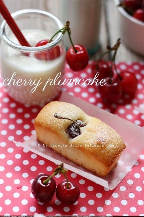 Cherry Plum Cake On A Plate With Cherries Next To It And A Glass Of Milk