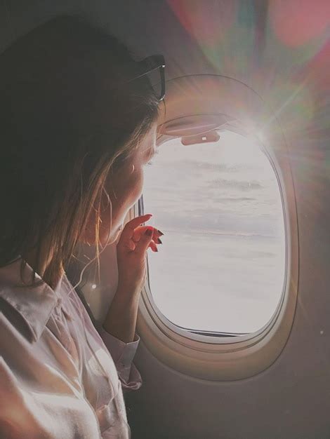 Premium Photo Woman Sitting In Airplane On Sunny Day