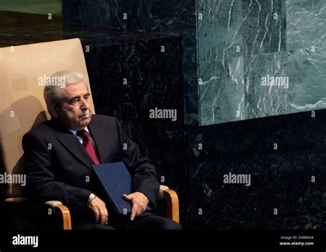 Demetris Christofias, the President of Cyprus, sits in a chair after