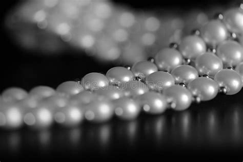 White Pearl Necklace On A Dark Background Black And White Stock Image