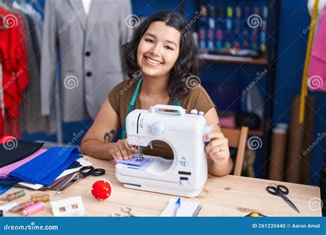 Young Woman Tailor Smiling Confident Using Sewing Machine At Sewing