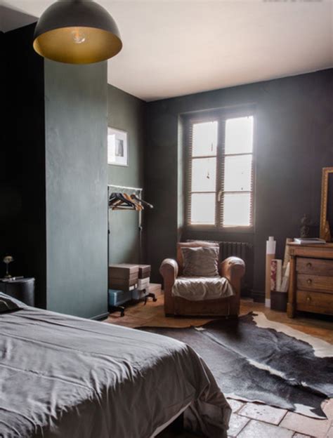 A Bedroom With Black Walls And Wooden Furniture