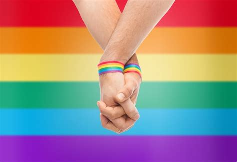 Premium Photo Hands Of Couple With Gay Pride Rainbow Wristbands