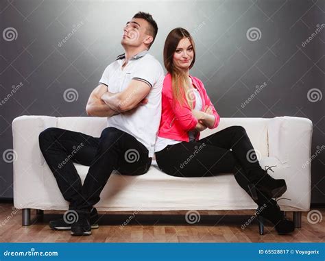 Young Couple After Quarrel Sitting On Sofa Back To Back Stock Image