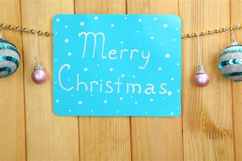 Premium Photo Signboard With Words Merry Christmas On Wooden Table