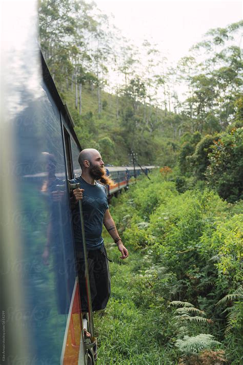 Man Standing In An Open Train Door By Stocksy Contributor Kike