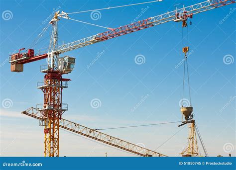 Tower Crane Lifting Up A Cement Bucket At Construction Area Stock Image