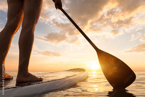 Foto De Stand Up Paddle Boarding On Quiet Sea Legs Close Up Sunset Do