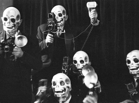 Beatrice Altariba With Photographers Wearing Skull Masks At Eyes