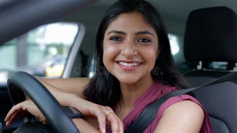 Young Indian Woman Sitting On Yoga Mat Doing Meditation Exercise At