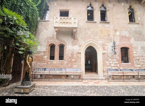 Balcony And Statue Of Juliet In The Casa De Giulietta In Verona