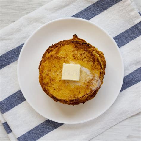 Homemade Corn Meal Johnny Cakes With Butter On A White Plate Top View