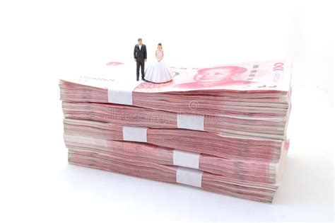 The Bride And Groom On Stacks Of Chinese Yuan Banknotes Stock Image