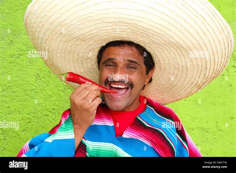 Mexican Man Poncho Sombrero Eating Red Chili Hot Pepper Mexico Stock Photo Alamy