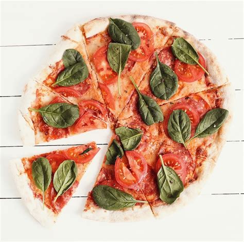 Free Photo Traditional Pizza With Tomato Slices And Basil Leaves