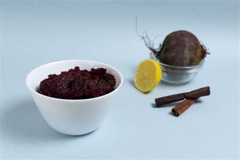 Natural Beet Jam In A White Bowl With Beets Lemon And Cinnamon Sticks On A Blue Background