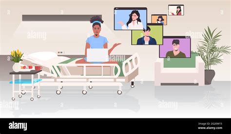 Pregnant Woman In Hospital Bed Chatting With Friends In Web Browser