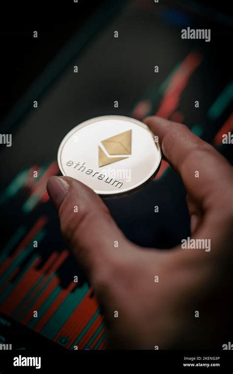 Hand Holding A Silver Ethereum Eth Cryptocurrency Coin With Candle