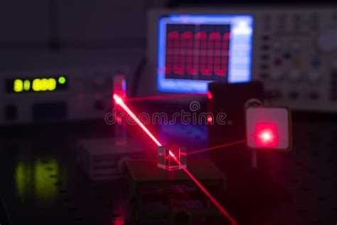 Experiment in Optic Lab with Laser Device. Red Laser on Optical Table ...