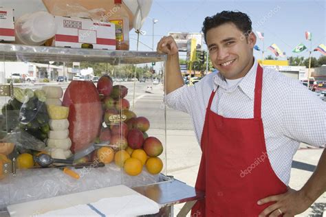 Street Vendor Standing By Stall — Stock Photo © Londondeposit 21977557