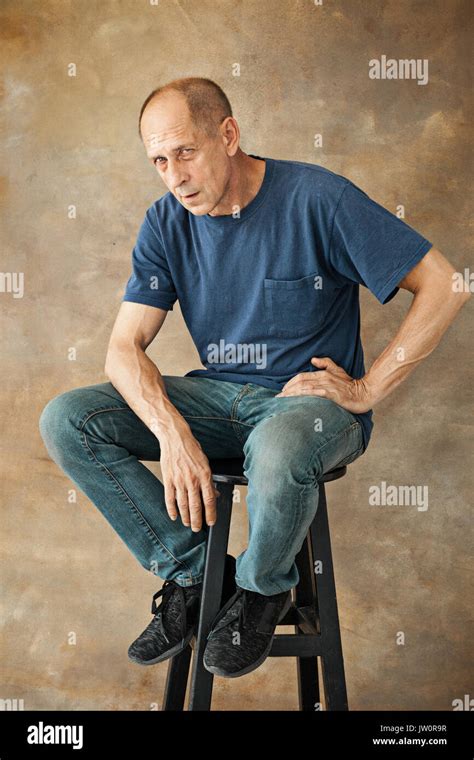 Worried Mature Man Sitting At Studio Stock Photo Alamy