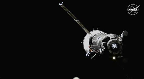 Soyuz Spacecraft Docks To Station With Three Crew Members Aboard Space Station