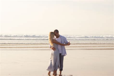 Pleased Male And Female Couple Spending Time At Beach Stock Image