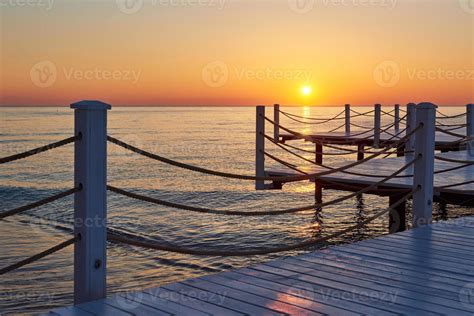 Wooden pier on a fancy orange sunset. 6227967 Stock Photo at Vecteezy