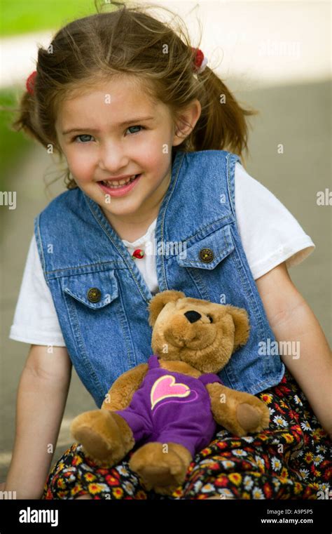 Portrait of young girl with teddy bear Stock Photo - Alamy