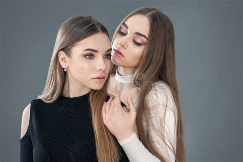 Two Sisters Posing Sitting Black And White Clothes Concept Of