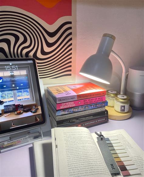 A Laptop Computer Sitting On Top Of A Desk Next To A Stack Of Books And