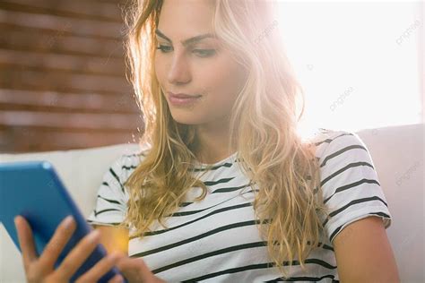 Pretty Blonde Using Tablet On Couch Domestic Life Abode Fashion Photo