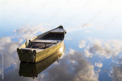 fishing boat in a calm lake water/old wooden fishing boat/ wooden ...