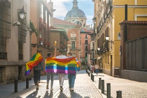 Premium Photo Man With His Back Facing The Demonstration With Rainbow Flags At Sunset Gay