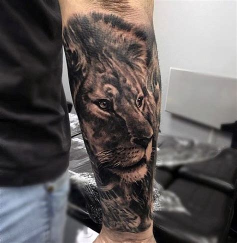 A Man With A Lion Tattoo On His Arm