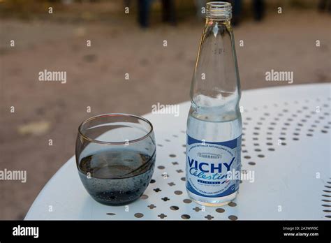 Glass Of Water And Bottle Of Vichy Celestins Served On The Terrace Of A