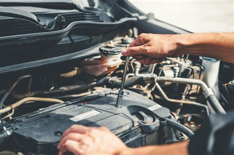 Premium Photo Cropped Hands Of Mechanic Repairing Car Engine